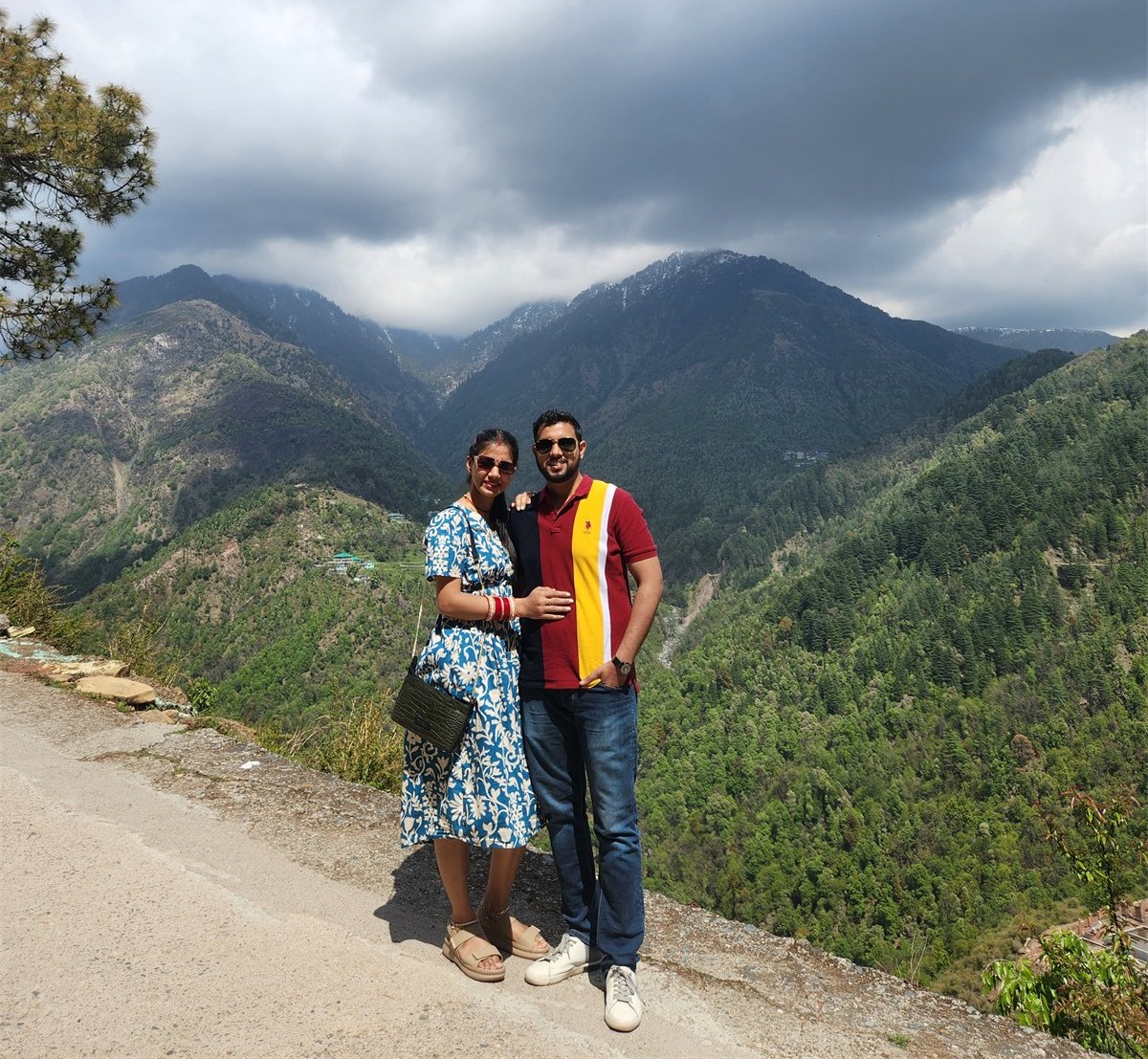 The two of us standing before a wide mountain landscape