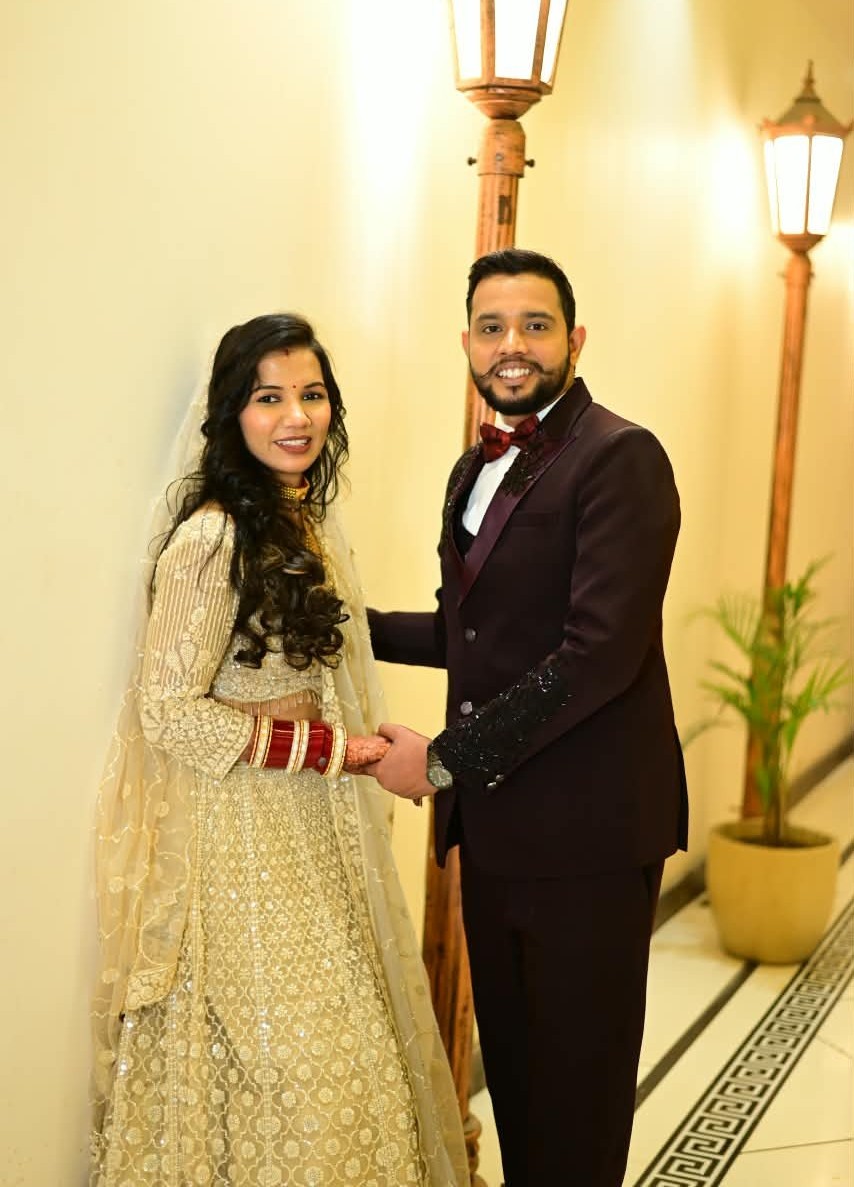 The two of us holding hands in formal wedding clothes