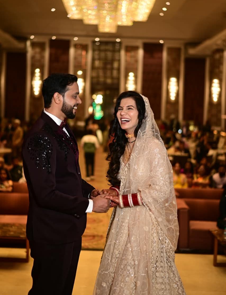 The two of us laughing together in wedding clothes