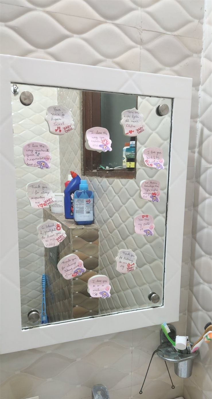 A bathroom mirror covered with handwritten love notes
