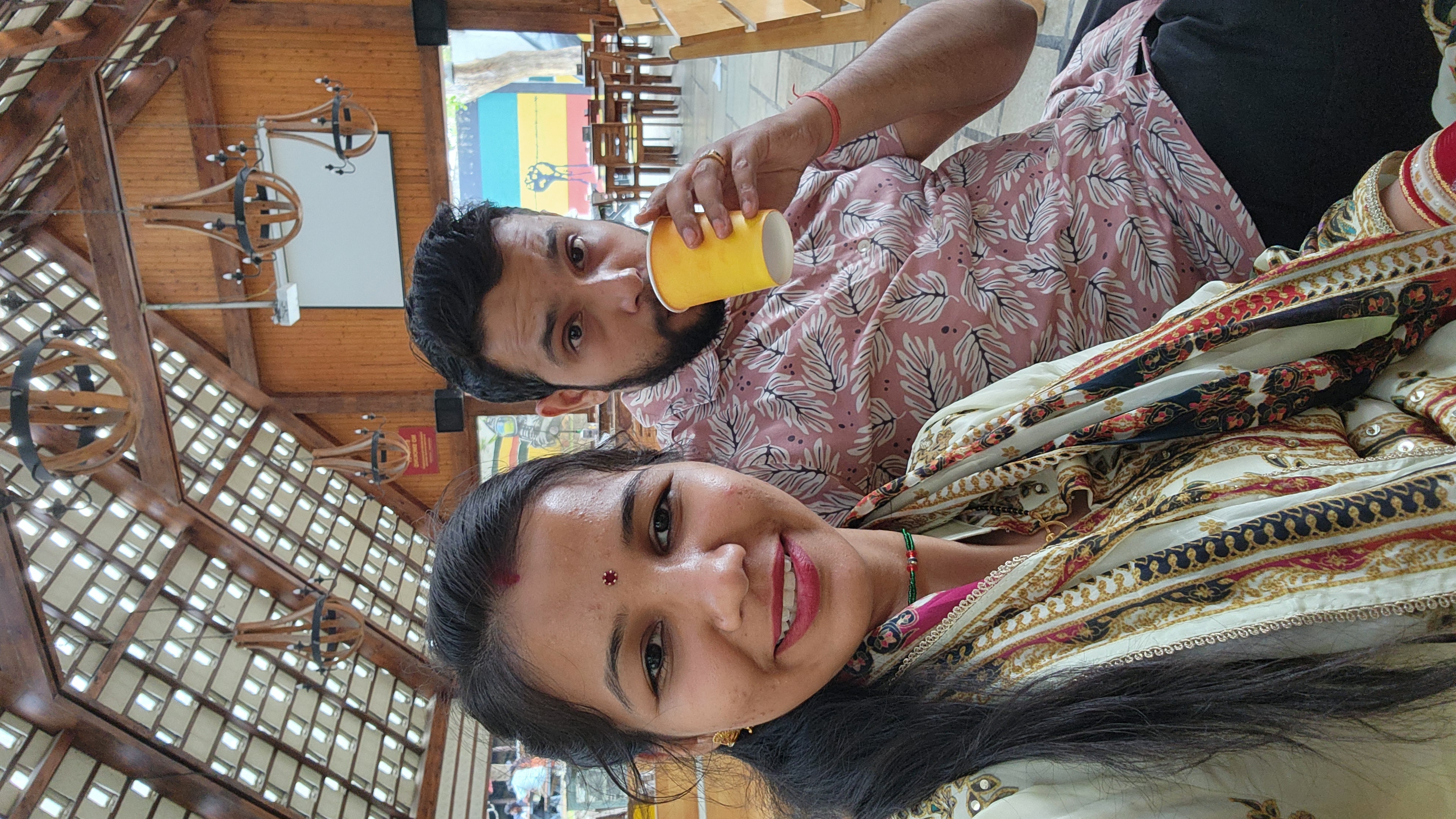 Couple sharing a cheerful selfie during a cafe stop