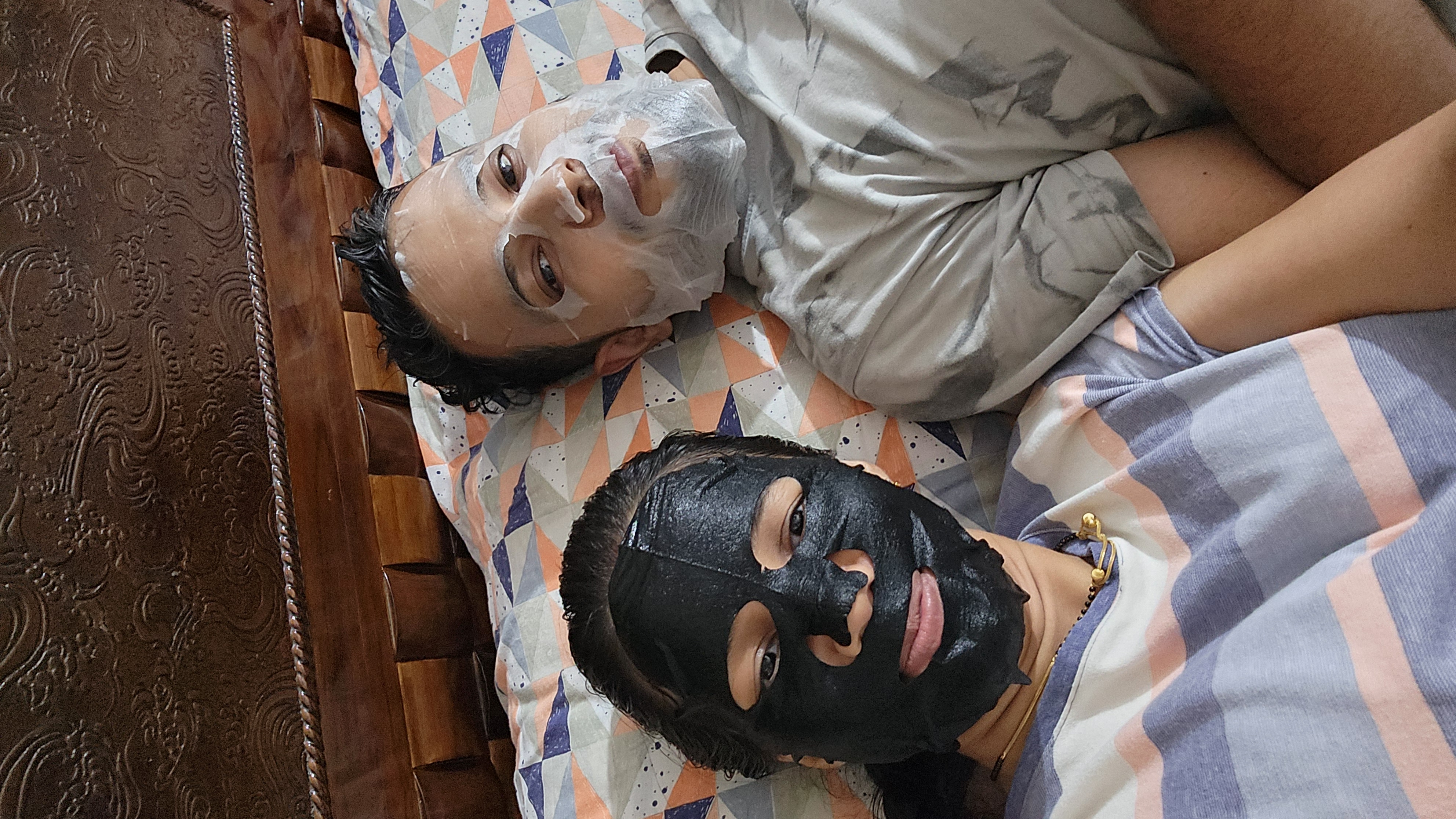 Couple relaxing together while wearing matching face masks