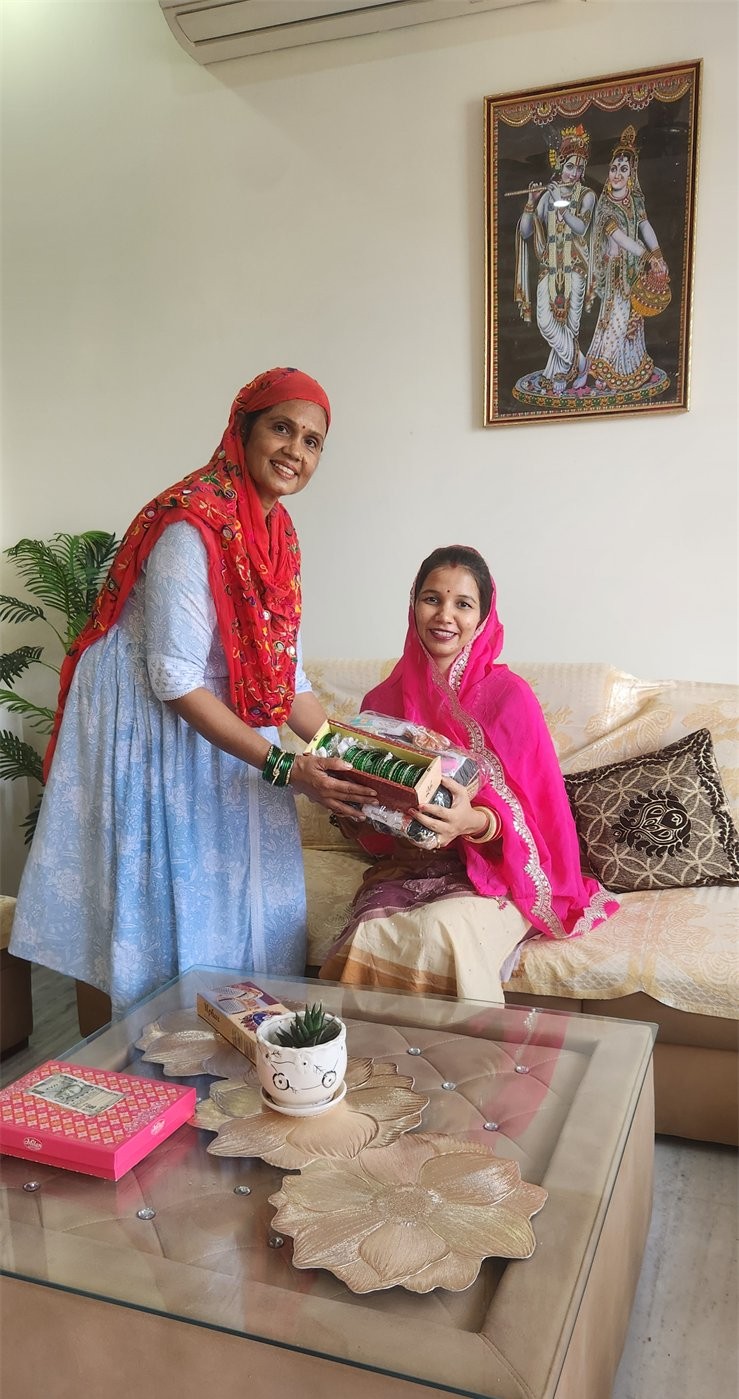 Two women sharing a gift during a family moment at home