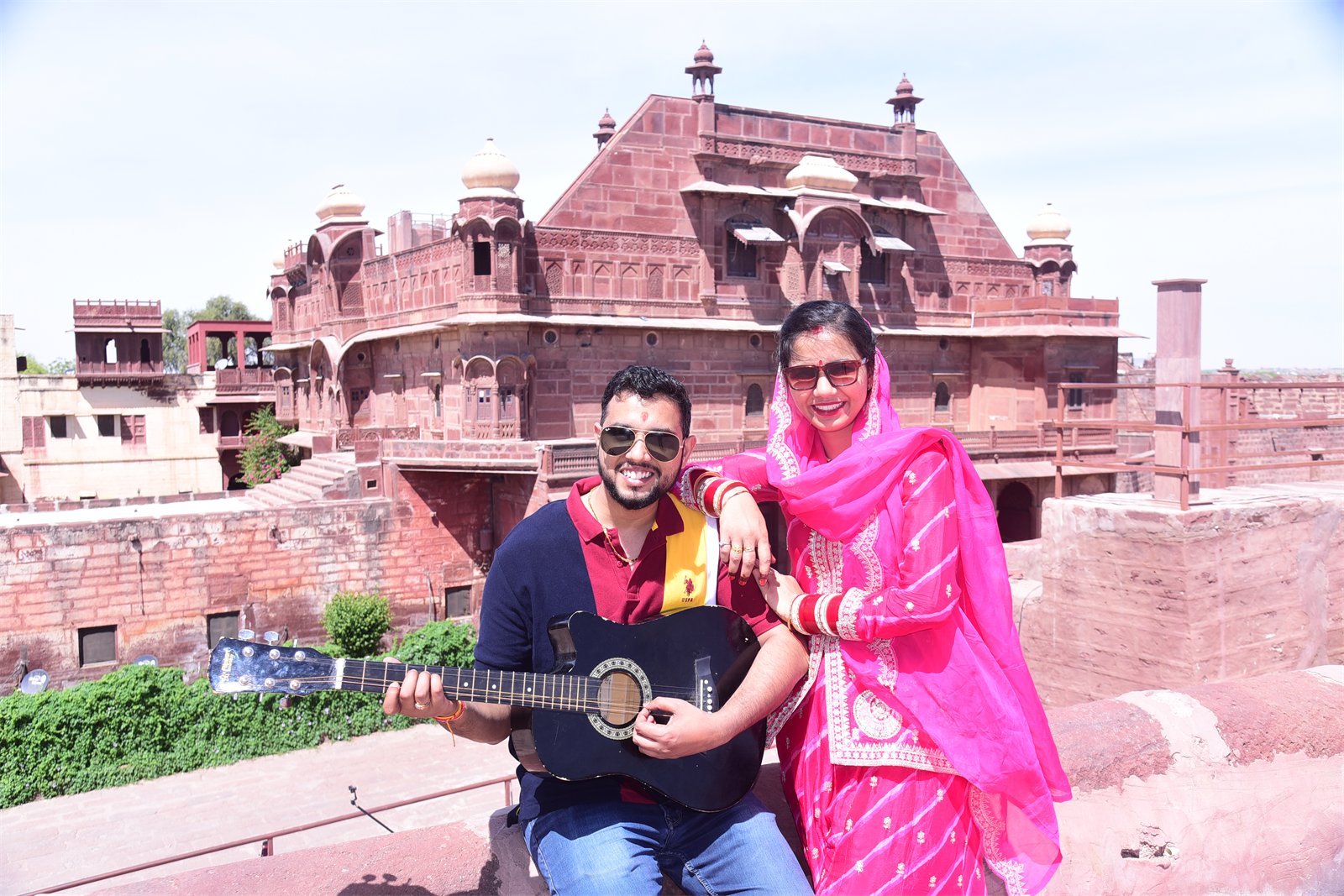 The two of us posing with a guitar at a red sandstone fort